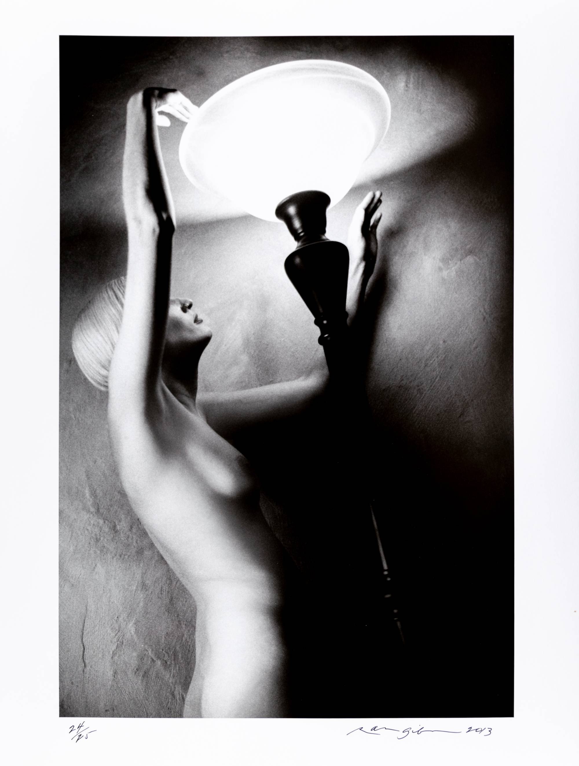 nude woman holding lamp shade